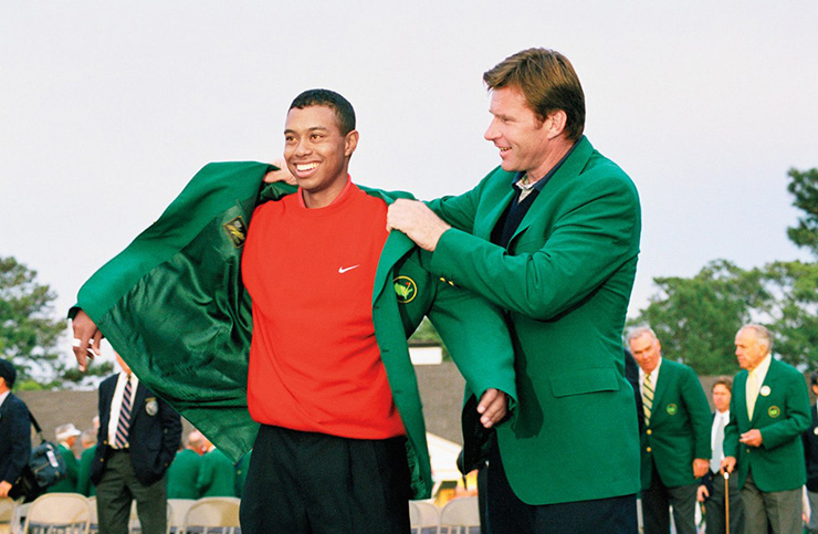 Tiger gets a hand from 1996 Masters winner Nick Faldo. Photo by Augusta National/Getty Images