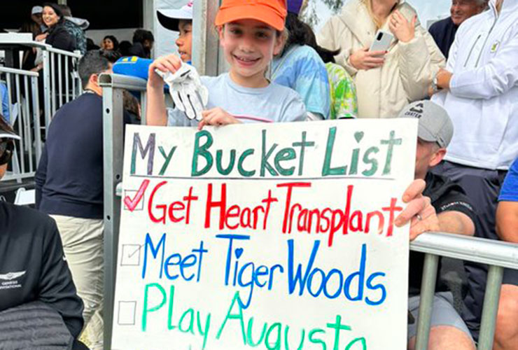 WATCH: Adorable clip shows caddie Joe LaCava notifying Tiger Woods of young fan’s ‘Bucket List’ poster