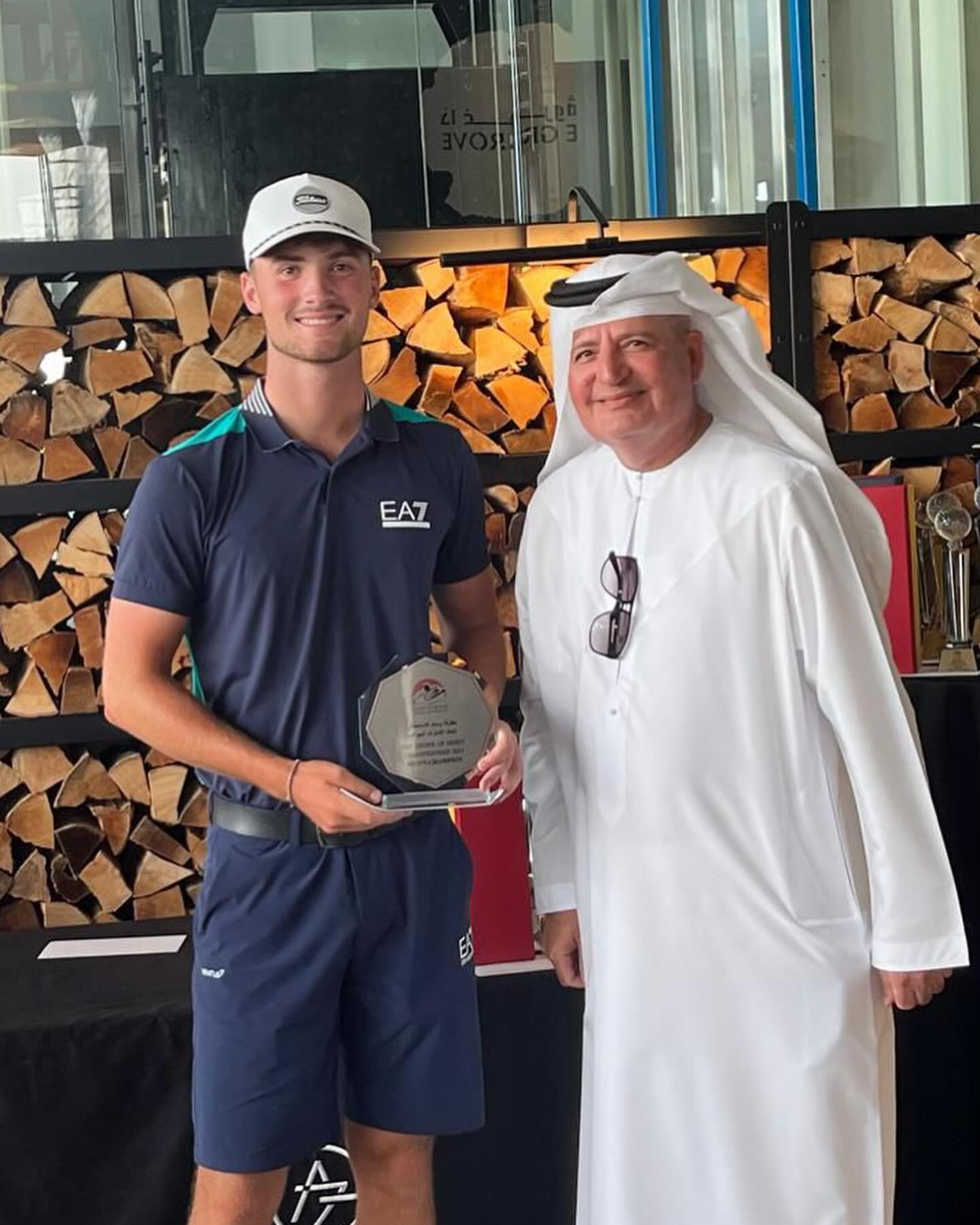 Dominic Morton (left), representing Trump International Golf Club, received the trophy from Walid Alattar, Board Member of the Emirates Golf Federation