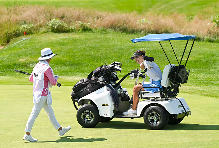 Bailey Bish smiles with her caddie after making par on the 12th hole during the final round of the 2024 U.S. Adaptive Open at Sand Creek Station. (Kathryn Riley/USGA)