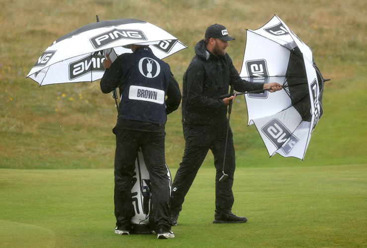 Daniel Brown and his caddie/brother Ben struggle with umbrellas at Royal Troon - Harry How