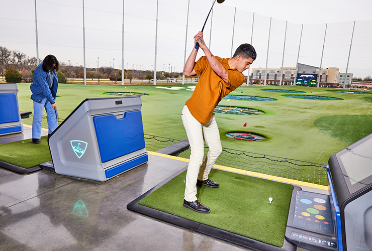 A young player enjoying a game at Topgolf