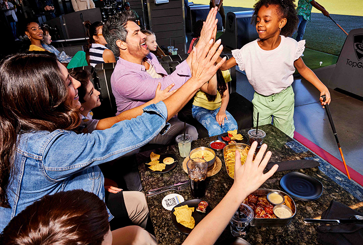 Families playing at Topgolf