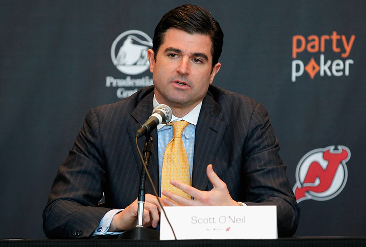 Scott O'Neil speaks at a New Jersey Devils press conference in 2014 - Andy Marlin